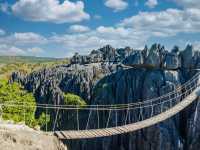 Walk across a suspension bridge to Tsingy de Bemaraha in Madagascar